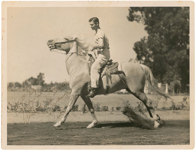 Item #14227 Clark Gable Signed Photo Riding on a White Horse. Clark Gable.