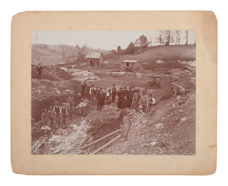 Item #18595 Photograph of African American men working in a rock quarry or mine. Photography...
