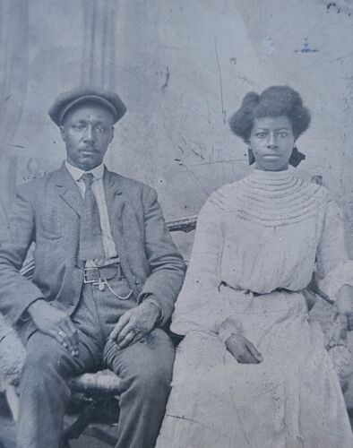 Item #18943 Tintype of African American Couple Sitting on a Loveseat. Photograph African American.